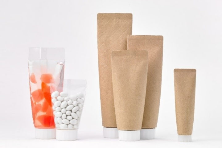 Paper-based material for body of easy to squeeze tube-shaped pouch further reduces plastic volume.