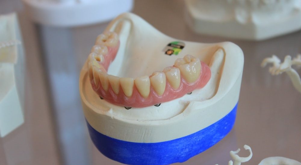 Dentures on white scale rack
