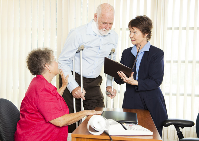 Injured man and his wife meet with a personal injury lawyer